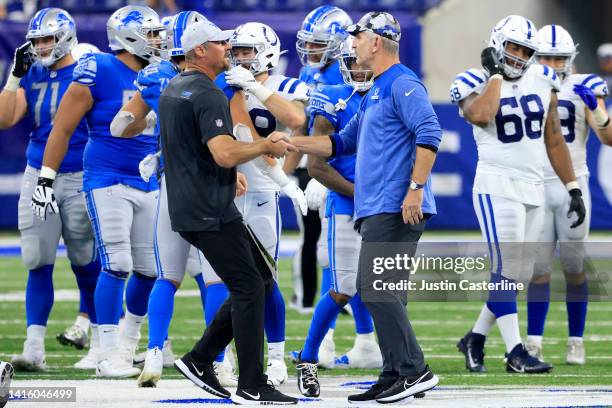 Head coach Frank Reich of the Indianapolis Colts and Head coach Dan Campbell of the Detroit Lions shake hands after the preseason game at Lucas Oil...