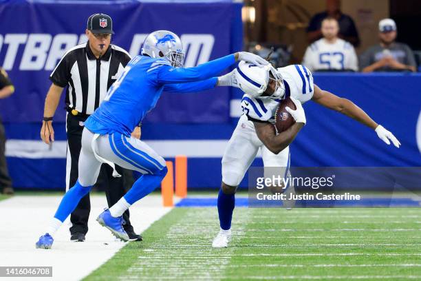 Saivion Smith of the Detroit Lions attempts to tackle D'vonte Price of the Indianapolis Colts at Lucas Oil Stadium on August 20, 2022 in...