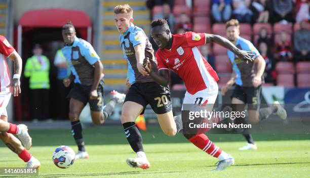 Dan Agyei of Crewe Alexandra moves forward with the ball watched by Harvey Lintott of Northampton Town during the Sky Bet League Two between Crewe...
