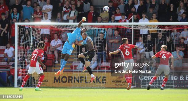 Arthur Okonkwo of Crewe Alexandra attempts to punch the ball under pressure from Danny Hylton of Crewe Alexand during the Sky Bet League Two between...