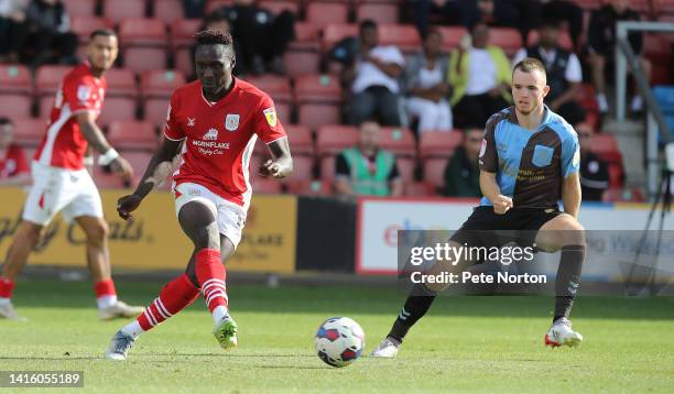 Dan Agyei of Crewe Alexandra plays the ball watched by Marc Leonard of Northampton Town during the Sky Bet League Two between Crewe Alexandra and...