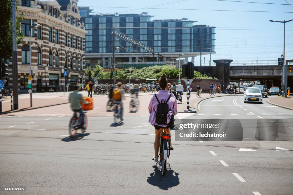 Woman cycling in Amsterdam, the Netherlands