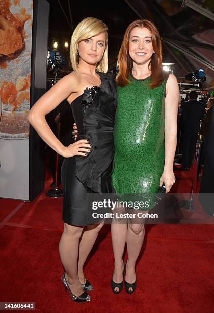 Actresses Mena Suvari and Alyson Hannigan arrive at the "American Reunion" Los Angeles Premiere March 19, 2012 in Hollywood, California.