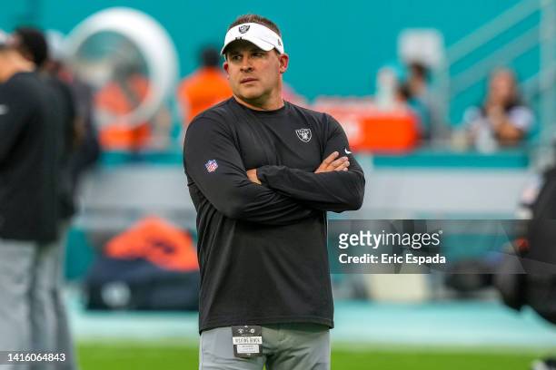 Head Coach Josh McDaniels of the Las Vegas Raiders watches his team warm up before the start of the game against the Miami Dolphins ​at Hard Rock...