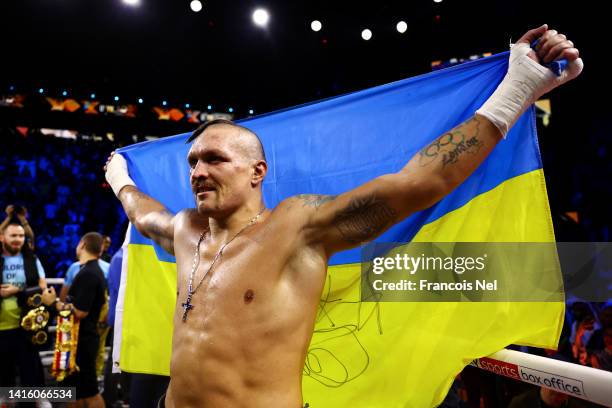 Oleksandr Usyk celebrates with a flag of Ukraine after their victory over Anthony Joshua in their World Heavyweight Championship fight during the...