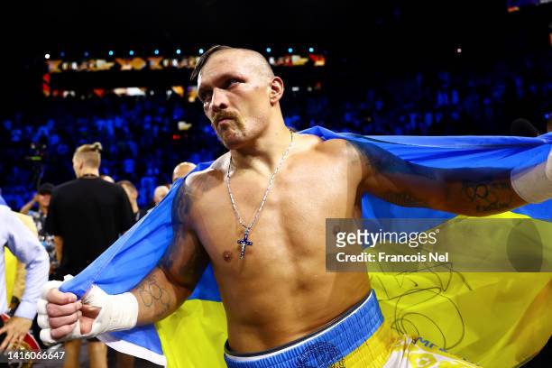 Oleksandr Usyk celebrates with a flag of Ukraine after their victory over Anthony Joshua in their World Heavyweight Championship fight during the...