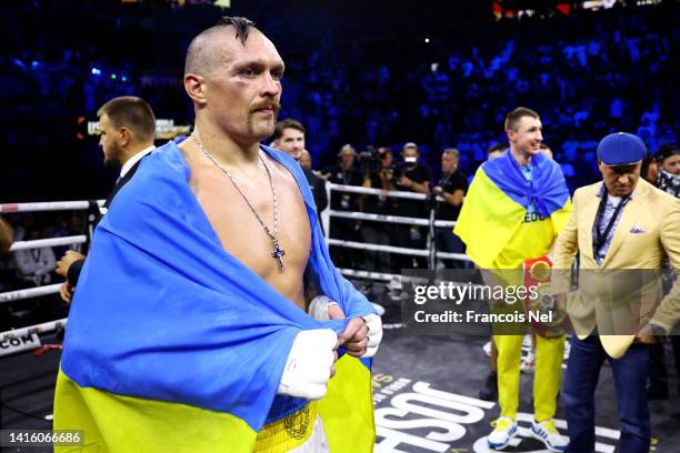 Oleksandr Usyk looks on with a flag of Ukraine after their victory over Anthony Joshua in their World Heavyweight Championship fight during the Rage...