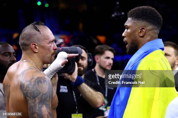 Oleksandr Usyk speaks with Anthony Joshua after their World Heavyweight Championship fight during the Rage on the Red Sea Heavyweight Title Fight at...