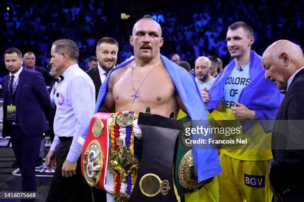 Oleksandr Usyk celebrates with their belts after their victory over Anthony Joshua in their World Heavyweight Championship fight during the Rage on...