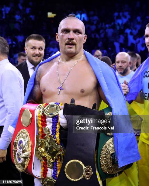 Oleksandr Usyk celebrates with their belts after their victory over Anthony Joshua in their World Heavyweight Championship fight during the Rage on...