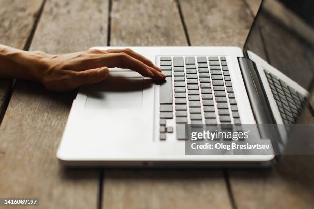 person's hands on laptop keyboard. distant job, freelance concept. remote work - touchpad bildbanksfoton och bilder