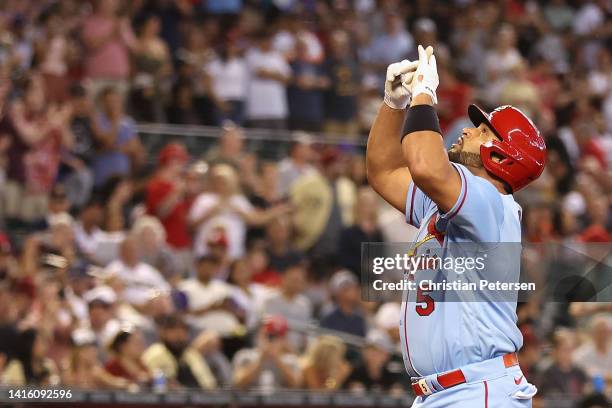 Albert Pujols of the St. Louis Cardinals reacts after hitting a solo home run against the Arizona Diamondbacks during the second inning of the MLB...