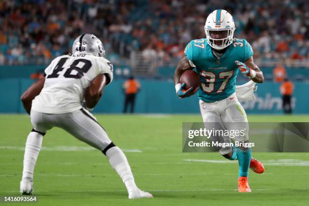 Myles Gaskin of the Miami Dolphins carries the ball during the second quarter against the Las Vegas Raiders at Hard Rock Stadium on August 20, 2022...