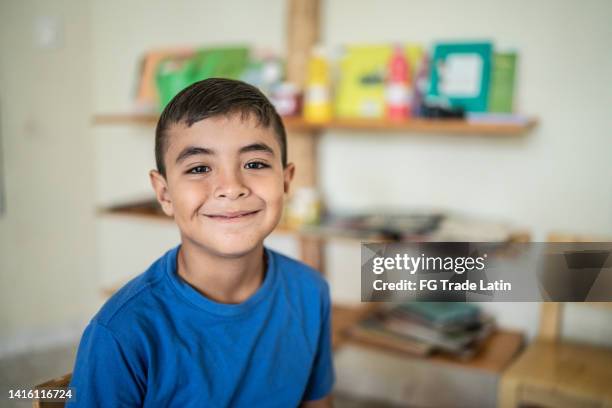 portrait of a schoolboy in the classroom at school - mini short stockfoto's en -beelden