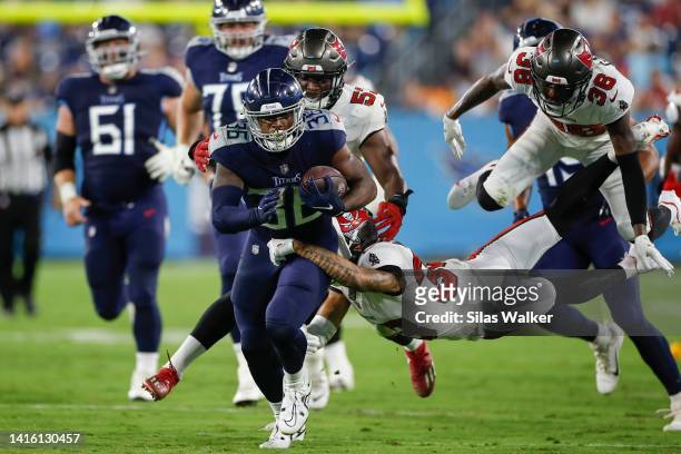 Julius Chestnut of the Tennessee Titans runs with the ball while being tackled by a Tampa Bay Buccaneer defender during fourth quarter of the...