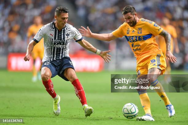 Maximiliano Meza of Monterrey fights for the ball with Andre-Pierre Gignac of Tigres during the 10th round match between Monterrey and Tigres UANL as...