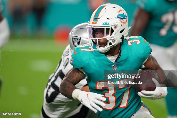 Myles Gaskin of the Miami Dolphins rushes the football during the fourth quarter against the Las Vegas Raiders at Hard Rock Stadium on August 20,...