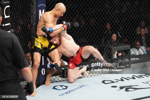 Jose Aldo of Brazil stops a takedown attempt from Merab Dvalishvili of Georgia in a bantamweight fight during the UFC 278 event at Vivint Arena on...