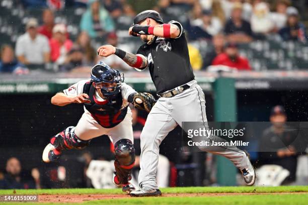 Catcher Luke Maile of the Cleveland Guardians tags out Yasmani Grandal of the Chicago White Sox at home during the sixth inning at Progressive Field...