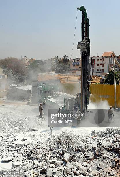 Borewell rig drilling into the earth spews dust on the outskirts of Bangalore on March 20, 2012 in wake of the annual 'World Water Day' observed on...