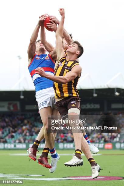 Will Day of the Hawks and Josh Dunkley of the Bulldogs compete for a mark during the round 23 AFL match between the Hawthorn Hawks and the Western...