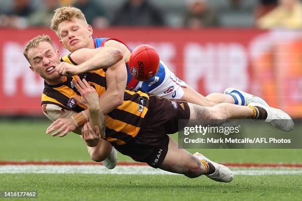 Tom Mitchell of the Hawks is tackled by Adam Treloar of the Bulldogs during the round 23 AFL match between the Hawthorn Hawks and the Western...