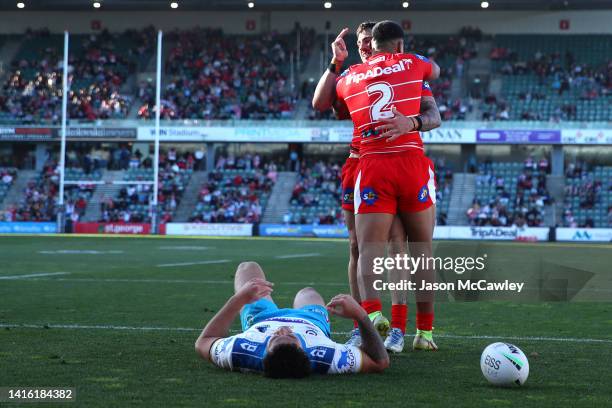 Jack Bird of the Dragons celebrates with Mathew Feagai of the Dragons after scoring a try during the round 23 NRL match between the St George...