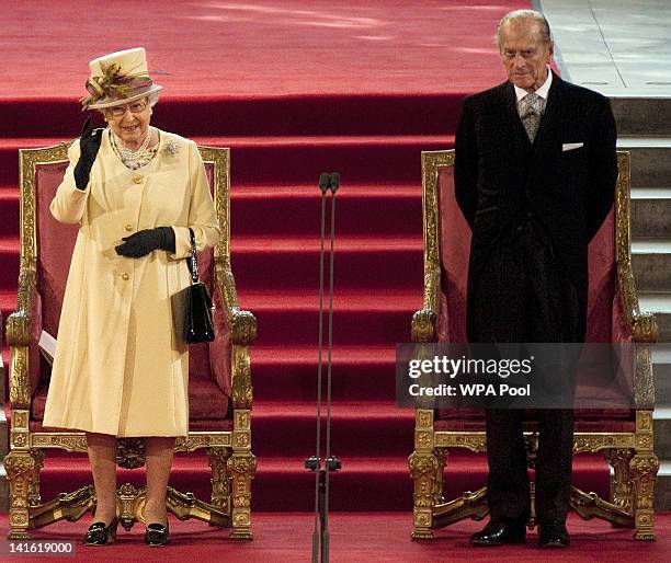 Prince Phillip, Duke of Edinburgh looks on as Queen Elizabeth II waves in Westminster Hall after addressing both Houses of Parliament on March 20,...