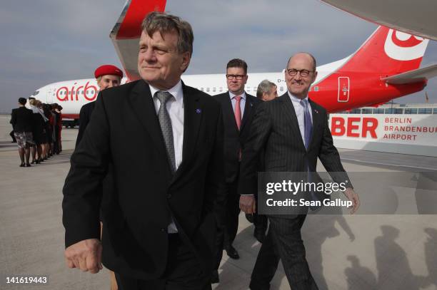 Air Berlin CEO Hartmut Mehdorn walks on the tarmac next to an Air Berlin passenger plane after he signed a document confirming Air Berlin's...