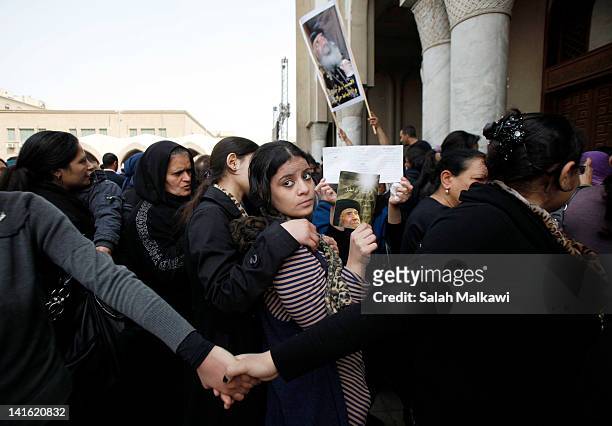 Egyptian Christians mourn during the funeral of Pope Shenouda III, the head of Egypt's Coptic Orthodox Church, at the Abassiya Cathedral at the...