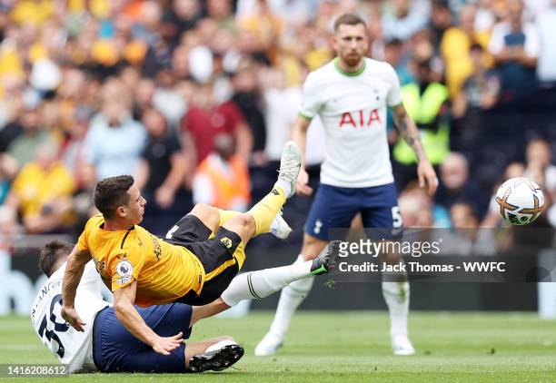 Daniel Podence of Wolverhampton Wanderers is challenged bis challenged by Rodrigo Bentancur of Tottenham Hotspur during the Premier League match...