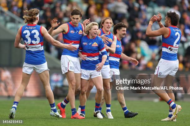 Sam Darcy of the Bulldogs celebrates kicking a goal with team mates during the round 23 AFL match between the Hawthorn Hawks and the Western Bulldogs...