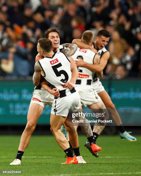 Jamie Elliott of the Magpies and Patrick Lipinski of the Magpies celebrate on the final siren after winnduring the round 23 AFL match between the...