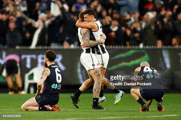 Zac Williams of the Blues and Adam Saad of the Blues look dejected as Jordan De Goey of the Magpies and Nick Daicos of the Magpies celebrate on the...