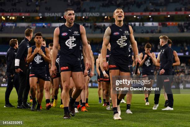 Patrick Cripps of the Blues and Jacob Weitering of the Blues lead the team off the field after the round 23 AFL match between the Carlton Blues and...