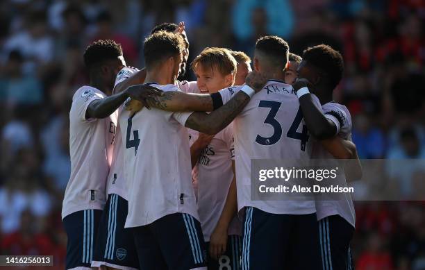 Martin Oedegaard of Arsenal celebrates with teammates after scoring their team's second goal during the Premier League match between AFC Bournemouth...