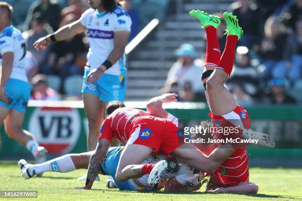 Jarrod Wallace of the Titans is tackled during the round 23 NRL match between the St George Illawarra Dragons and the Gold Coast Titans at WIN...