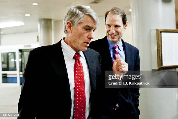 Sen. Jeff Bingaman , left, talks with U.S. Sen. Ron Wyden as they head to a weekly policy meeting at the Capitol on March 20, 2012 in Washington, DC....
