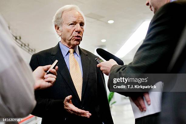 Sen. Joe Lieberman speaks with members of the press as Senate Democrats head to a weekly policy meeting at the Capitol on March 20, 2012 in...