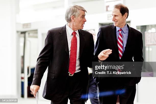Sen. Jeff Bingaman , left, talks with U.S. Sen. Ron Wyden as they head to a weekly policy meeting at the Capitol on March 20, 2012 in Washington, DC....