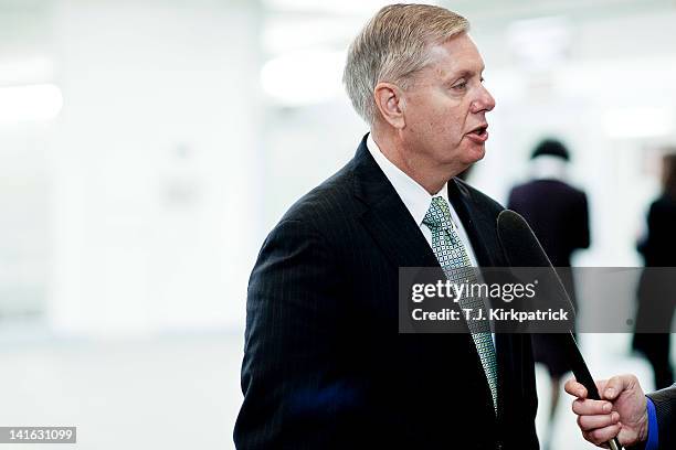 Sen Lindsey Graham talks with the press as Senate Republicans head to a weekly policy meeting at the Capitol on March 20, 2012 in Washington, DC. The...