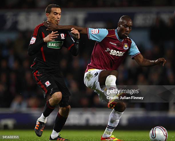 Carlton Cole of West Ham holds off Seb Hines of Middlesbrough during the npower Championship match between West Ham United and Middlesbrough at...
