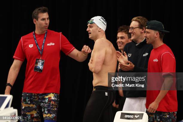 Australia team captain Grant Hackett and team mates talk to Sam Williamson of Australia as he competes in the Men’s 3x50m Breaststroke Skins during...