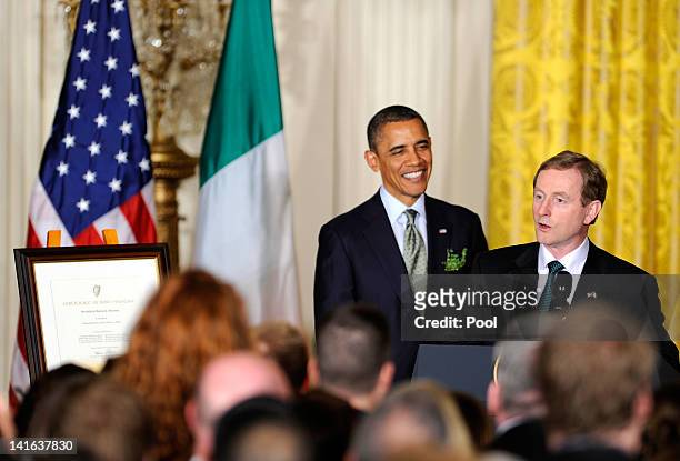 Irish Prime Minister Enda Kenny makes remarks as U.S. President Barack Obama listens after Kenny presented Obama with a certificate of Irish heritage...