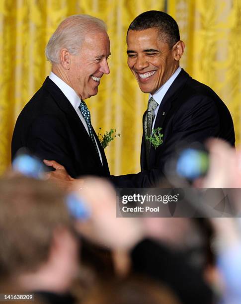 President Barack Obama is welcomed by U.S. Vice President Joe Biden as he arrives for a reception for Irish Prime Minister Enda Kenny in the East...