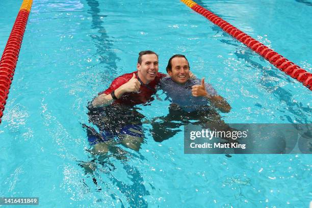 Australia team captain Grant Hackett and USA team captain Aaron Peirsol embrace in the pool after the 2022 Duel in the Pool at Sydney Olympic Park...