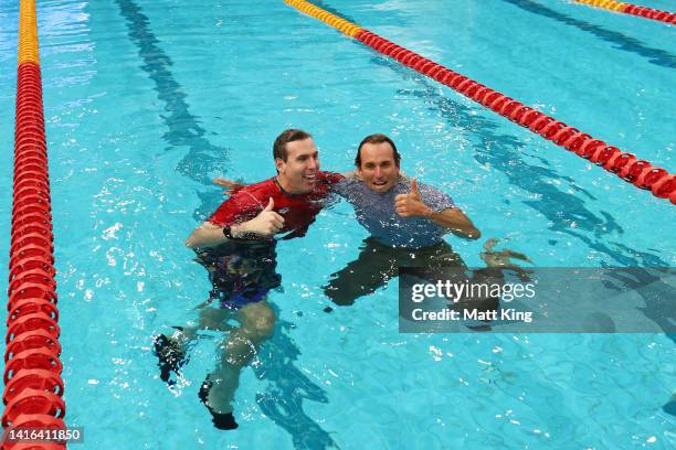 Australia team captain Grant Hackett and USA team captain Aaron Peirsol embrace in the pool after the 2022 Duel in the Pool at Sydney Olympic Park...