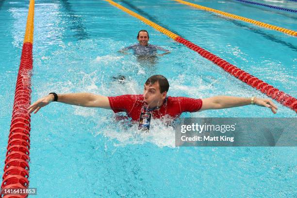 Australia team captain Grant Hackett and USA team captain Aaron Peirsol embrace in the pool after the 2022 Duel in the Pool at Sydney Olympic Park...