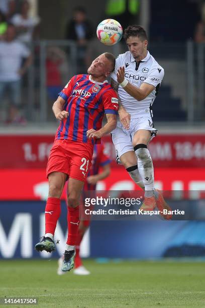 Adrian Beck of 1. FC Heidenheim is tackled by Ivan Lepinjica of DSC Arminia Bielefeld during the Second Bundesliga match between 1. FC Heidenheim...