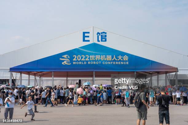 Visitors crowd at the entrance of 2022 World Robot Conference at Beijing Etrong International Exhibition & Convention Center on August 21, 2022 in...
